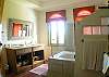 Master Bathroom with two sinks on a marble top, combination shower/jetted bathtub and walk-in closet, inside the Master Bedroom at Villa Oceana vacation rental home in Esterillos, Costa Rica, half way between Jaco and Manuel Antonio.