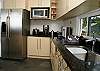 Kitchen with stainless steel appliances and granite countertop at Casa Infinito luxury vacation rental home at Valle Perdido in Playa Hermosa, Costa Rica