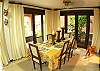 This is the beautiful decorated dining room with table for six an access to the terrace at La Flor beachfront gated community on the North side of Jaco beach Costa Rica