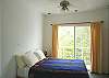 Bedroom 3 with view of the rainforest, Queen bed and closet at Casa Infinito luxury vacation rental home at Valle Perdido in Playa Hermosa, Costa Rica