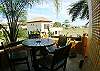 Small terrace with table and chairs just outside of the kitchen, at Casa Tortuga vacation rental house at Hermosa Palms in Playa Hermosa, Puntarenas, Costa Rica