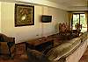 Living area with seating area with TV and dining table at Casa Colonial at Hermosa Palms gated community in Playa Hermosa, Costa Rica