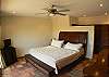 Master Bedroom with ocean view, wood frame King Bed, TV, ample closet space and ensuite bathroom at Casa Colonial at Hermosa Palms gated community in Playa Hermosa, Costa Rica