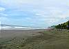 Palm fringed beach in front of Hermosa Palms gated community in Playa Hermosa, Puntarenas, Costa Rica