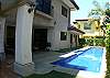 Pool area with terrace including charcoal BBQ, lounge chairs and table at Casa Colonial vacation rental home at Hermosa Palms in Playa Hermosa, Puntarenas