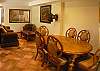Living area with dining table and seating area with TV at Casa Colonial at Hermosa Palms gated community in Playa Hermosa, Costa Rica