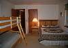 A queen and 2 twin beds in this room.
