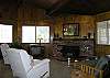 Located in the living room, fireplace has a wood insert. Open to the kitchen and dining area.