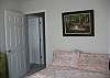 This bedroom has a full size bed and is located on the main level.