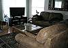 Nicely appointed living room with leather sofa and love seat and a flat screen TV with DVD.  Located on the upper level and is open to the dining and kitchen area.