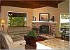 Nicely appointed living room with a corner fireplace.