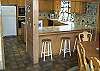 located on the main level and is open to the dining area and living room.  Extra seating for 3 at the breakfast bar.
