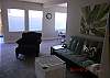 Cozy and bright living area. Complete with Flat Screen TV, internet, Cable and a peak of the ocean from the dining area!