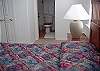 Kingsize bed in Master bedroom along with Cable TV, full bathroom, and access to outside upper deck.