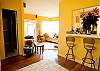 The dining room table folds against the wall to tuck out of the way when not in use. This beach house is bright and spacious.