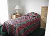 One bedroom offers 2 twin beds and access to the upper outside deck through sliding doors.
