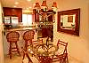 The kitchen area is open and features a breakfast bar, dining area and a bistro set for two in the kitchen.