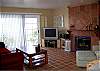 This beach house has the California feel with fireplace, tile floors and great private patio from the living room.