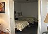 This beach house sleeps six, this room features two twin beds and has an attached bath.
