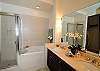 Luxury Master Bathroom EnSuite features double sinks, jacuzzi soaking tub and shower.  Luxury bathrobes provided.