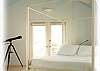 Enjoy watching the sun set over the gulf with the telescope left for guests to use. French doors take you out onto the balcony