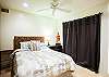 second bedroom with queen bed and shared bath