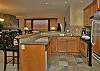 Kitchen with heated slate floor, granite counter tops and stainless steel appliances.