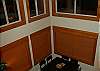 Looking down from the loft at the main floor dining table with 20 foot ceilings and view of groomed ski trail acess.