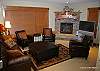 Ground floor-Lounge with Gas fire place, leather sofas, flat screen TV, with X-Box. Windows over look groomed ski run.