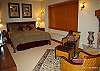 Top floor- master bedroom with king size bed and view of ski trail.