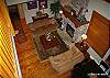 Aerial view of main floor living room from loft on the floor above. Gas fire place, high vaulted ceilings, 2nd dining table with 8 seats.
