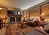 Lounge room with gas fireplace, comfy leather sofas, and a 42" flat screen TV with DVD player