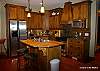 Main floor-Fully equipped kitchen has a wood top island/breakfast bar and double sink, otherwork surfaces are granite.