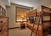 Single-over-single bunk bed with roll away under bottom bunk in the third bedroom.