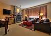 Living room with slate clad fire place and solid wood mantle, leather lounge suite, 42" wall mounted TV with DVD player.
