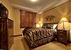 Queen bed, bedside tables, large picture window looks over hot tub and mountain beyond and has a private bathroom.