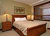 Queen bed, window overlooks hot tub.