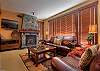 Living room with gas fireplace, leather sofas and views of the mountains.