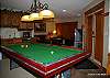 Ground floor-Pool table and lounge area, with doorway to hot tub, ski locker and ski-in, ski-out trail.