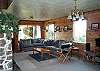 Second view - Lower level - Living room with TV/DVD, wood burning fireplace, hide a bed for additional sleeping and door out to large grassy backyard.