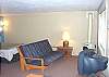 This is the living room in the studio on the lower level. Equipped with TV, futon and foos ball table.  Beautiful ocean views as well!!
