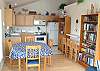 Second view - Upper level - Fully equipped kitchen with bar for 3 and dining table for 4 with one extra chair.