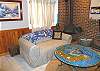 Lower level - Family room with love seat, wood stove and TV/VCR/DVD.