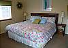 Second view of Upper level Master Bedroom with a King bed, TV and slider to deck.
