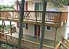 Lower and upper level decks with patio furniture and Gas BBQ.  Lower deck has stairs down to grassy backyard.