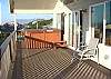 Upper wrap around deck with hot tub, spectacular ocean views and gas BBQ.
