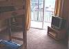 Second view - Lower level - Bedroom with a Twin Bunk bed, TV/DVD and a slider out to lower deck.