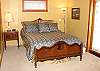 Upper level - Master Bedroom with a Queen bed and access to hot tub and back deck.
