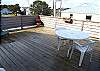 Deck off living room with table and 5 chairs and beautiful ocean views.