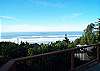 View of ocean from inside the house, lower deck and hot tub.